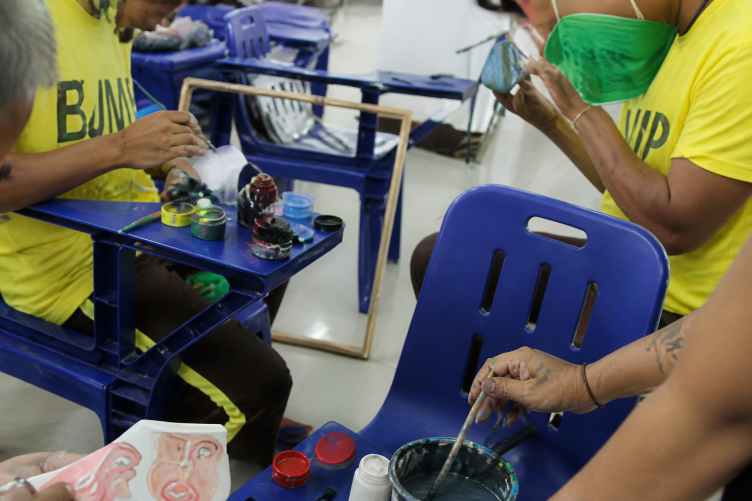 Participants taking part in a hands-on painting class